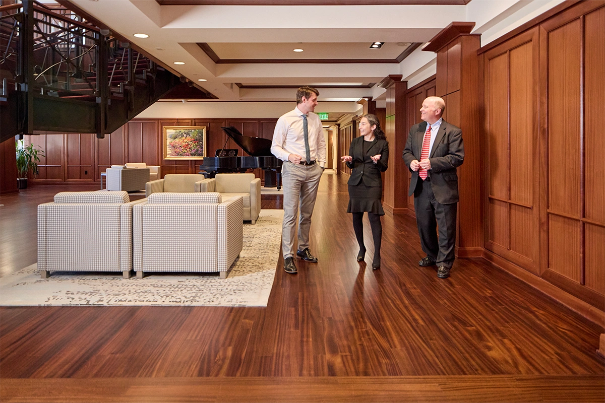 Kirton McConkie lawyers talking in the KeyBank Tower downtown office building.