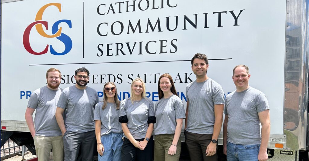Group of volunteers in front of a Catholic Community Services Truck